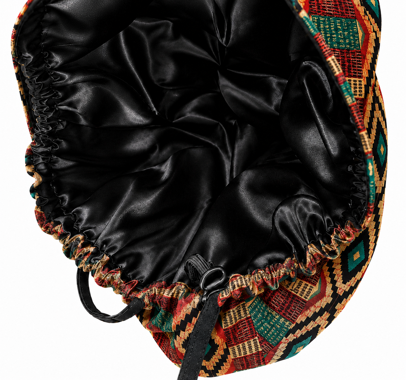 Empowered Energy African Kente ponytail scrub cap flat lay showing black satin lining interior traditional Ghana diamond pattern orange green teal surgical hat handmade USA