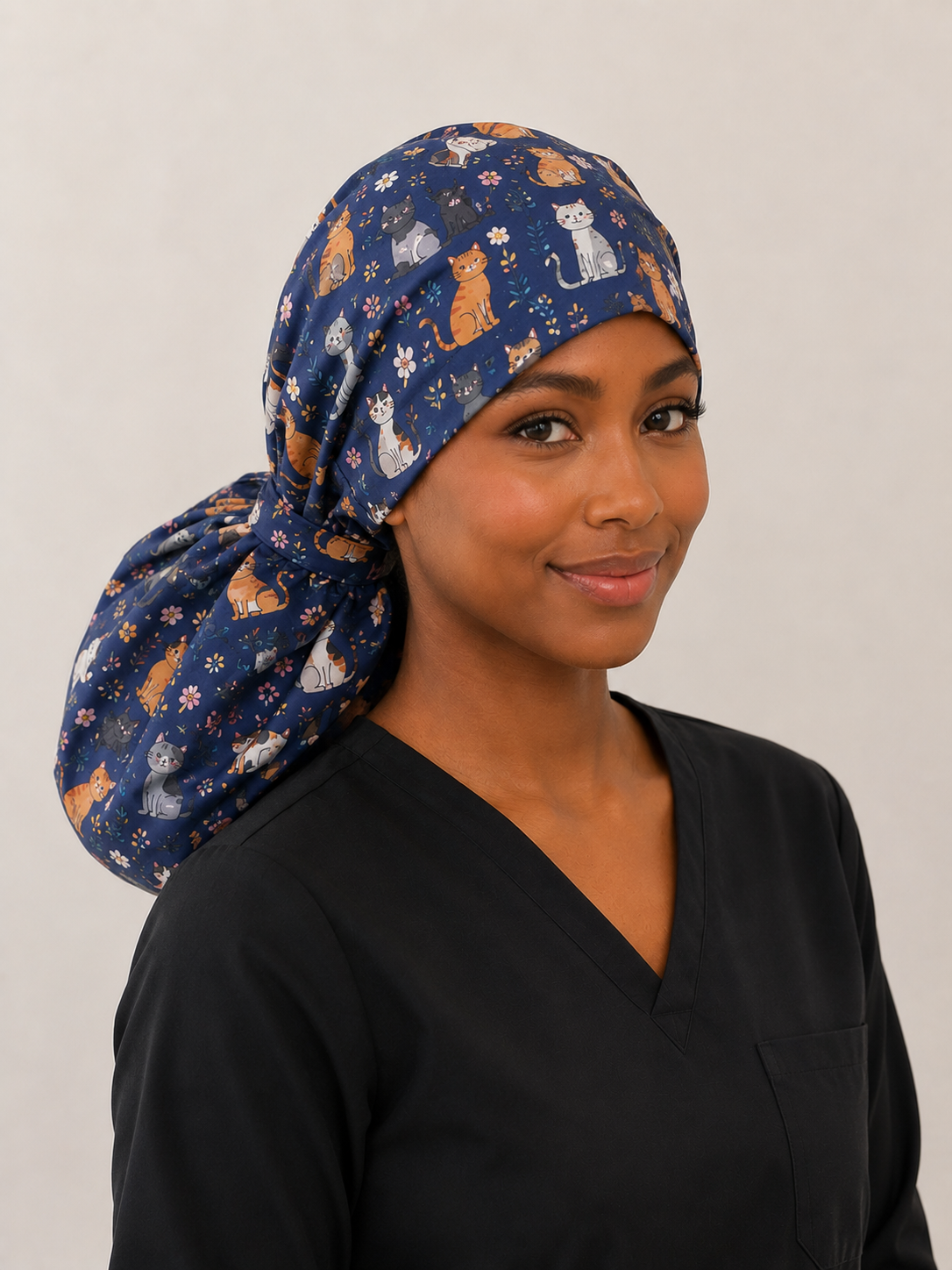 XXL ponytail scrub cap cats and floral print front view on model extra large surgical hat for long thick natural hair OR World handmade USA