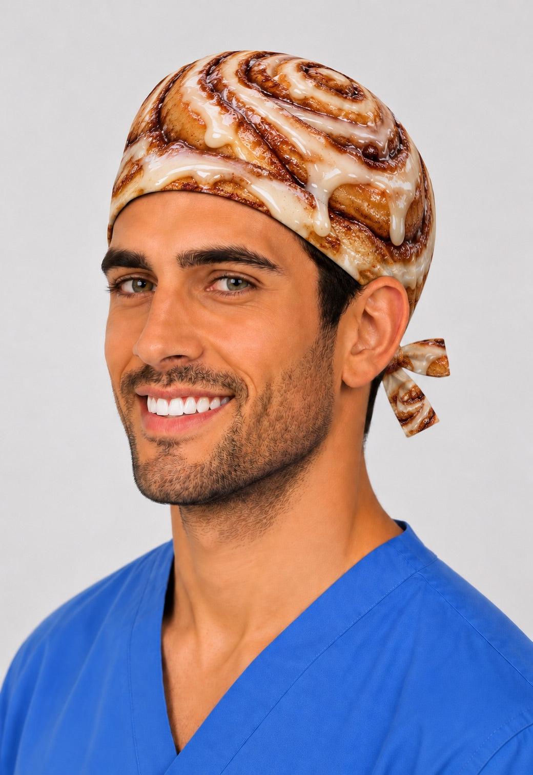 Smiling male nurse in a photorealistic cinnamon roll tie-back scrub cap, men's scrub caps and surgical hats for surgeons, male nurses and OR techs by OR World