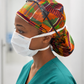 African Kente XL Ponytail Scrub Cap for Women with Satin Lining, Ghana Kente Print Surgical Hat, Adjustable Scrub Cap for Long Hair, Nurses, Surgical Techs, Doctors and Healthcare Professionals. Nurse wearing surgical hat 