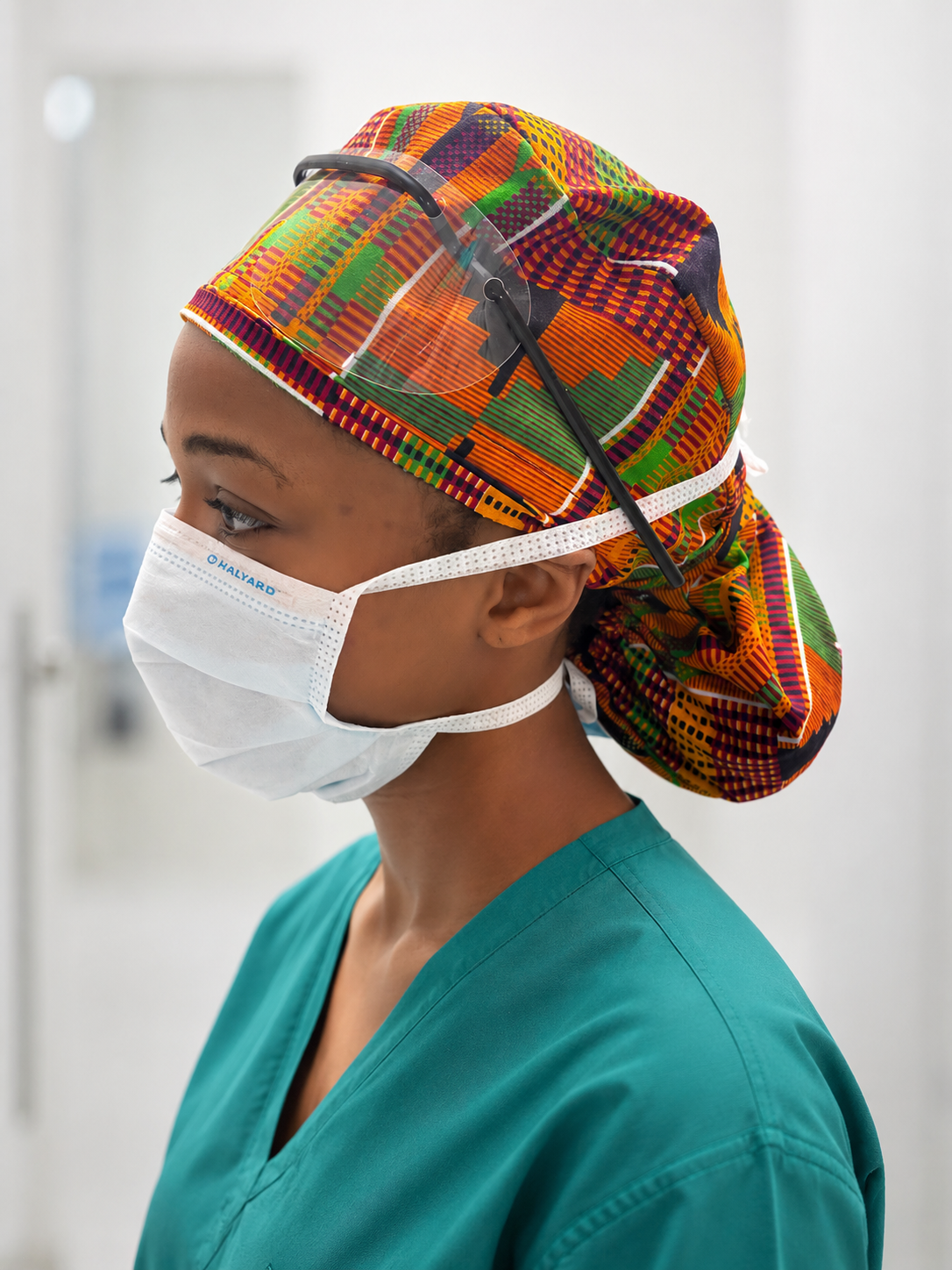 African Kente XL Ponytail Scrub Cap for Women with Satin Lining, Ghana Kente Print Surgical Hat, Adjustable Scrub Cap for Long Hair, Nurses, Surgical Techs, Doctors and Healthcare Professionals. Nurse wearing surgical hat 