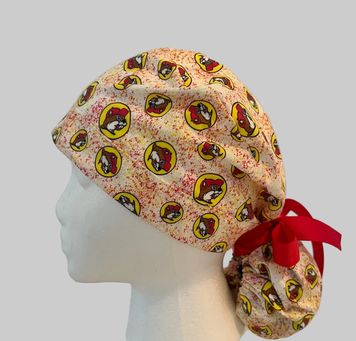 Beaver Print Ponytail Scrub Cap, Red and Yellow and Adjustable Surgical Cap for Nurses and Healthcare Workers Hat, left side view