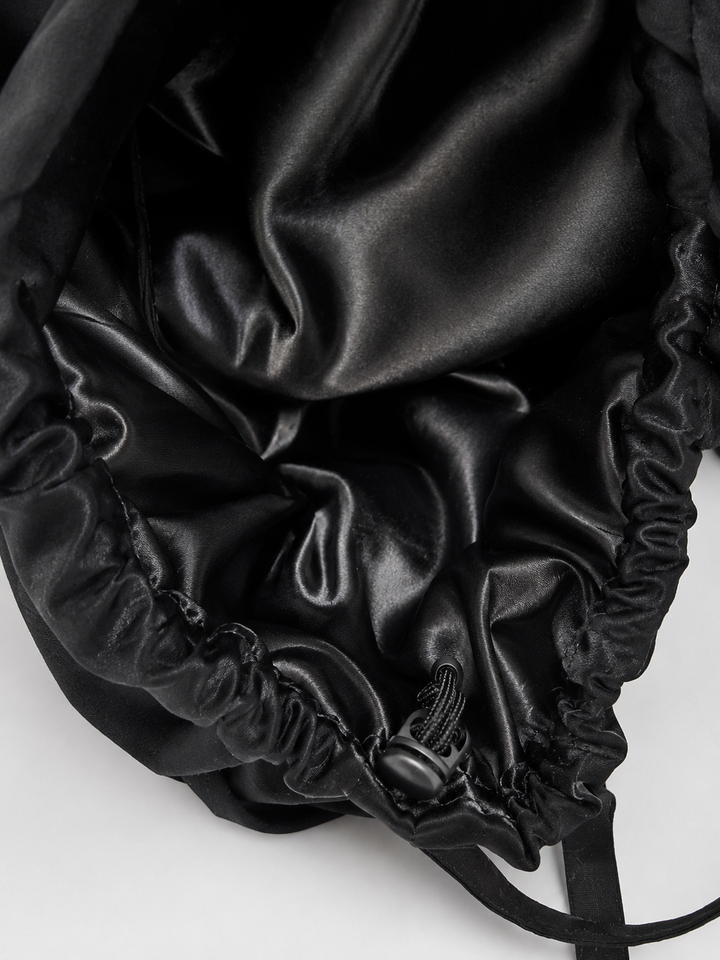 Inside view of black XL ponytail scrub cap showing black satin lining interior