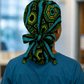 Colorful Spirit African print ponytail scrub cap back view showing full cap shape and bold geometric teal green gold pattern handmade USA