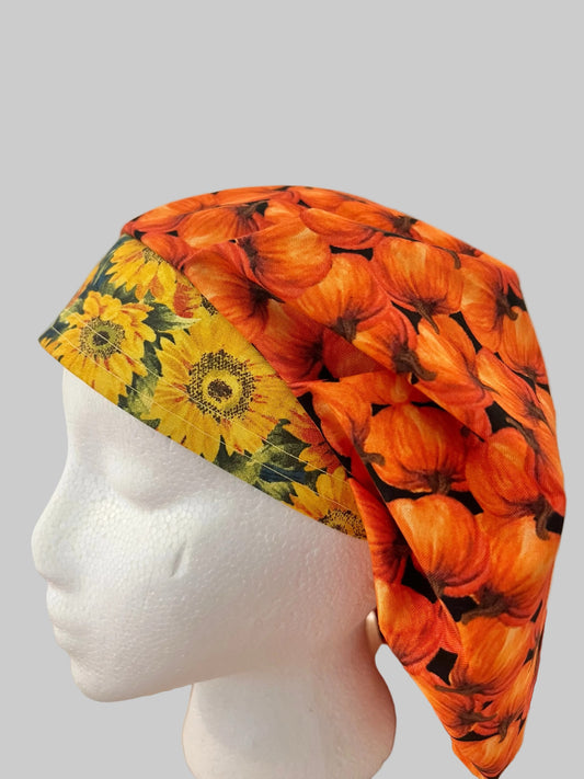 Fall pumpkin bouffant scrub cap with orange pumpkins and yellow sunflower band, side view, handmade by OR World