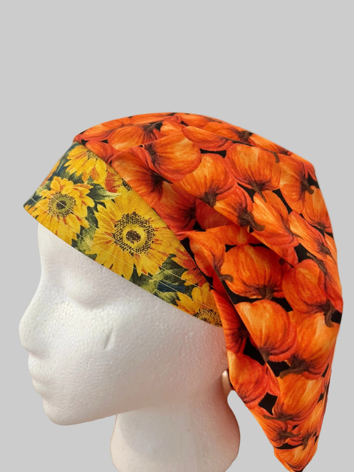 Fall pumpkin bouffant scrub cap with orange pumpkins and yellow sunflower band, side view, handmade by OR World