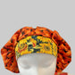 Fall pumpkin bouffant scrub cap for women, front view with yellow sunflower band, autumn surgical hat, OR World