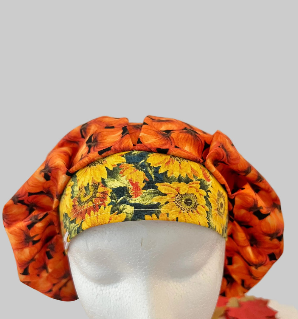 Fall pumpkin bouffant scrub cap for women, front view with yellow sunflower band, autumn surgical hat, OR World