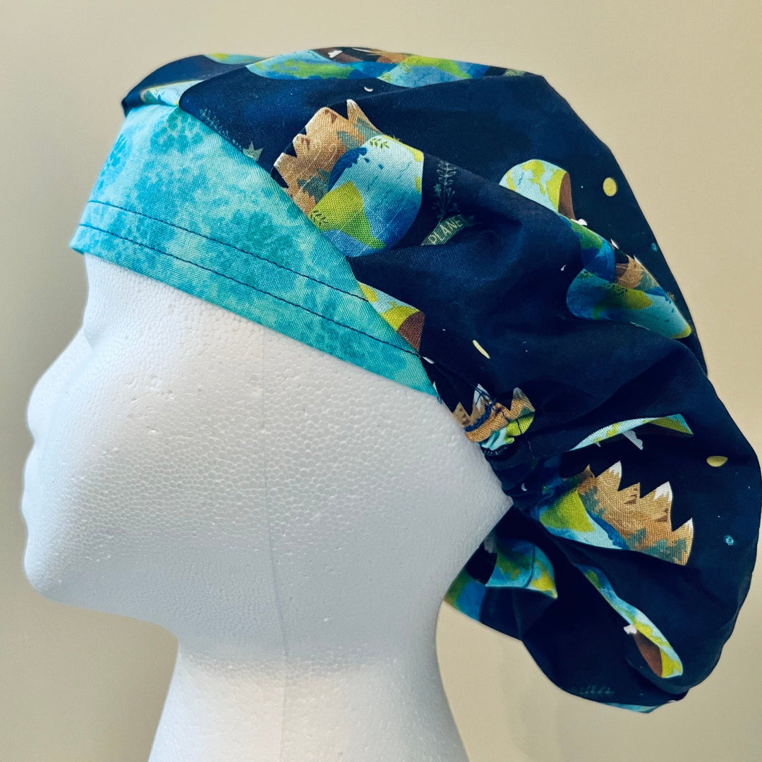 Side view of Save the Planet bouffant scrub cap with earth print on navy — handmade-in-USA surgical hat, meaningful gift for nurses &amp; surgeons.