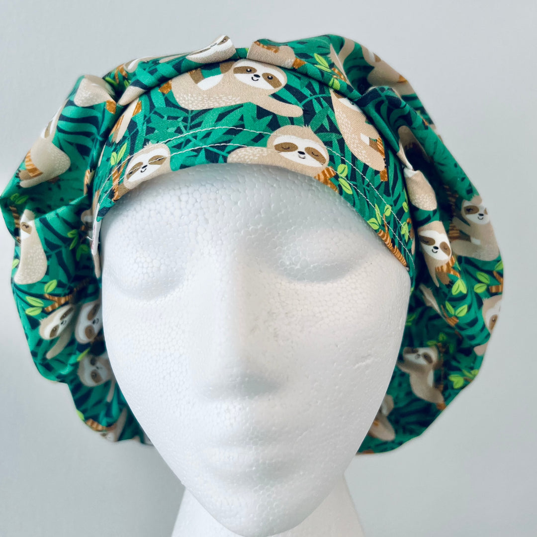Cute Sloth Euro Scrub Cap featuring tropical jungle leaves. Adjustable unisex OR cap with optional satin lining available. Perfect gift for nurses, surgeons, veterinarians, surgical techs, and healthcare workers.