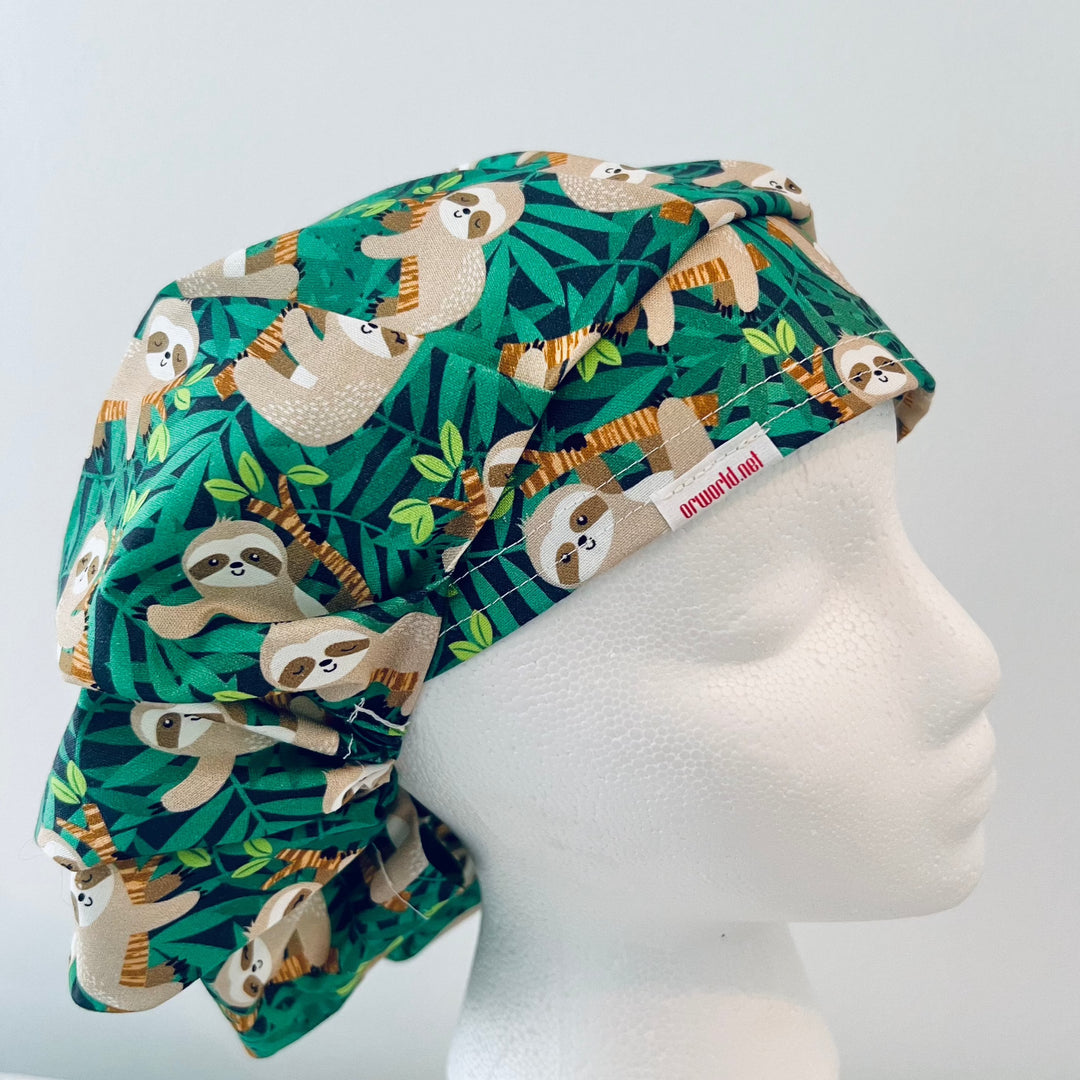 Cute Sloth Euro Scrub Cap featuring tropical jungle leaves. Adjustable unisex OR cap with optional satin lining available. Perfect gift for nurses, surgeons, veterinarians, surgical techs, and healthcare workers.