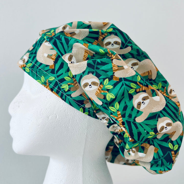 Cute Sloth Euro Scrub Cap featuring tropical jungle leaves. Adjustable unisex OR cap with optional satin lining available. Perfect gift for nurses, surgeons, veterinarians, surgical techs, and healthcare workers.