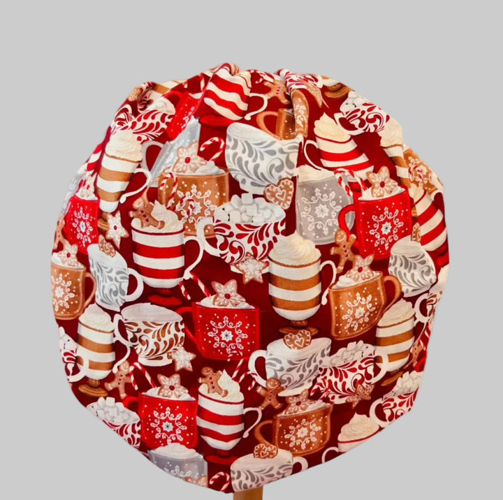 Christmas hot chocolate and marshmallow bouffant scrub cap with festive cocoa mugs, peppermint, gingerbread cookies, marshmallows, snowflakes, and snowman band for nurses, surgeons, dietitians, and medical professionals, back view.