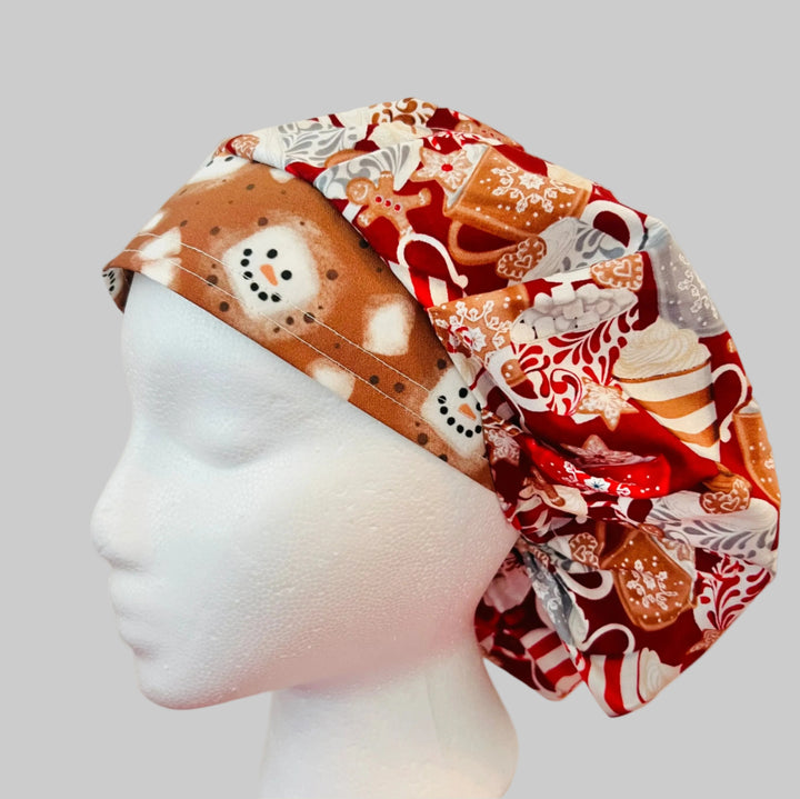 Christmas hot chocolate and marshmallow bouffant scrub cap with festive cocoa mugs, peppermint, gingerbread cookies, marshmallows, snowflakes, and snowman band for nurses, surgeons, dietitians, and medical professionals, left side view.