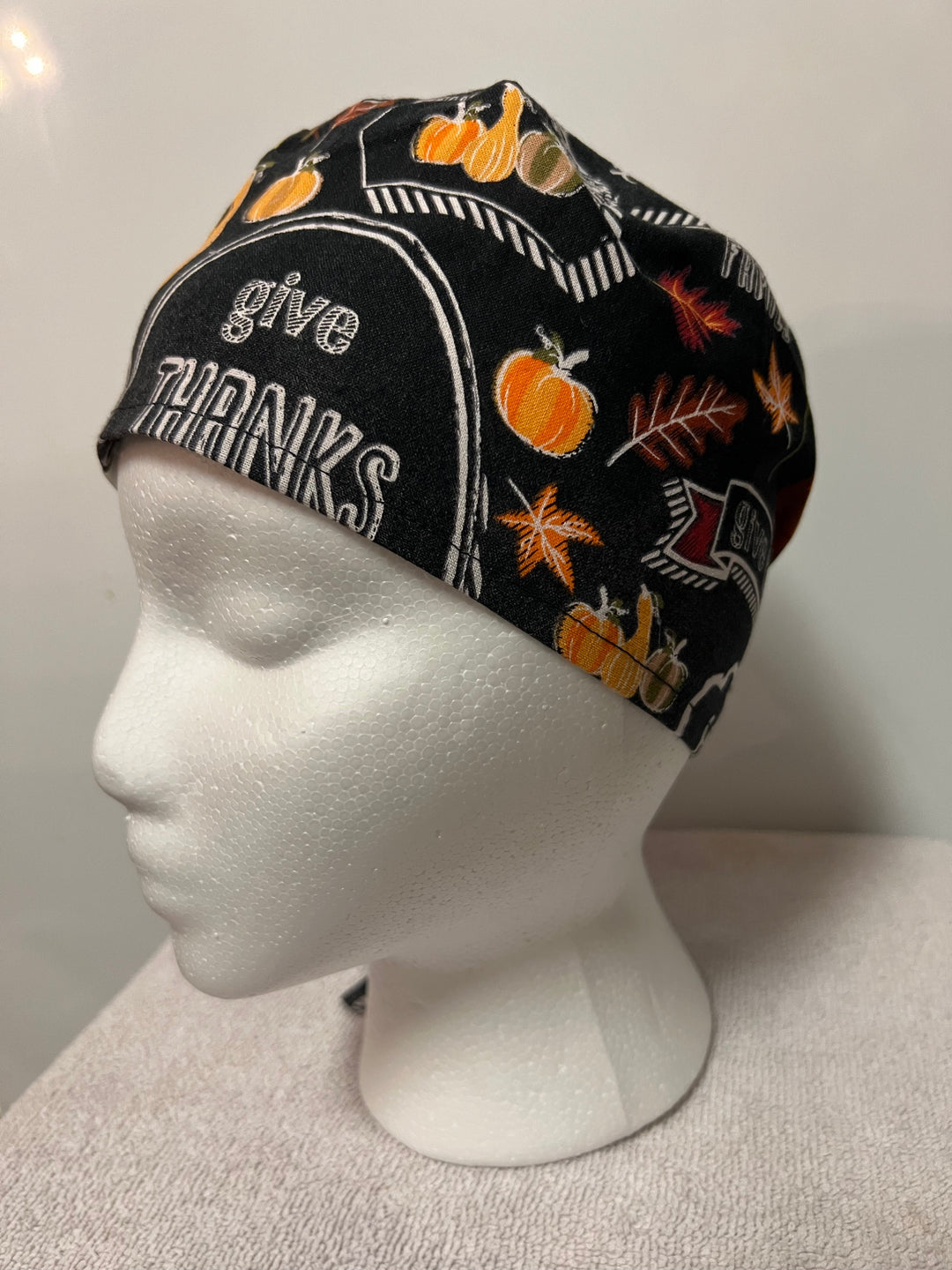 Thanksgiving "Blessed & Thankful" tie-back scrub cap with fall lettering on a model — handmade-in-USA surgical hat from OR World.