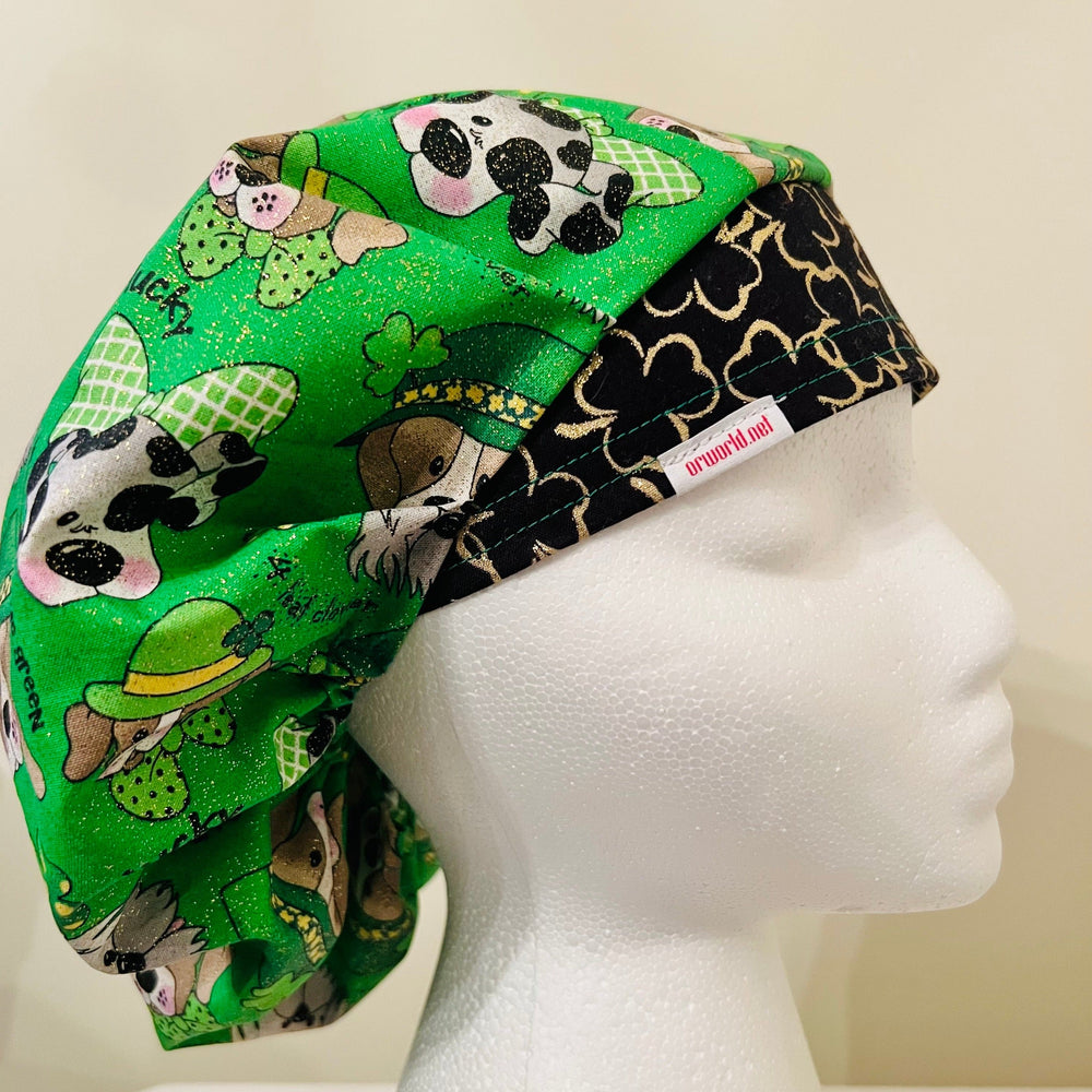 St. Patrick's Day bouffant scrub cap with festive puppies and gold four-leaf clovers on a model — handmade-in-USA surgical hat for women from OR World.
