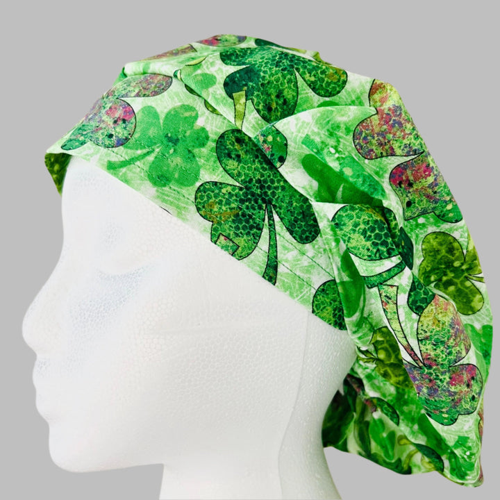Top view of purple &amp; green clover bouffant scrub cap — handmade-in-USA St. Patrick&