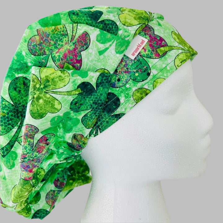 Side view of watercolor four-leaf clover bouffant scrub cap — handmade USA St. Patrick&