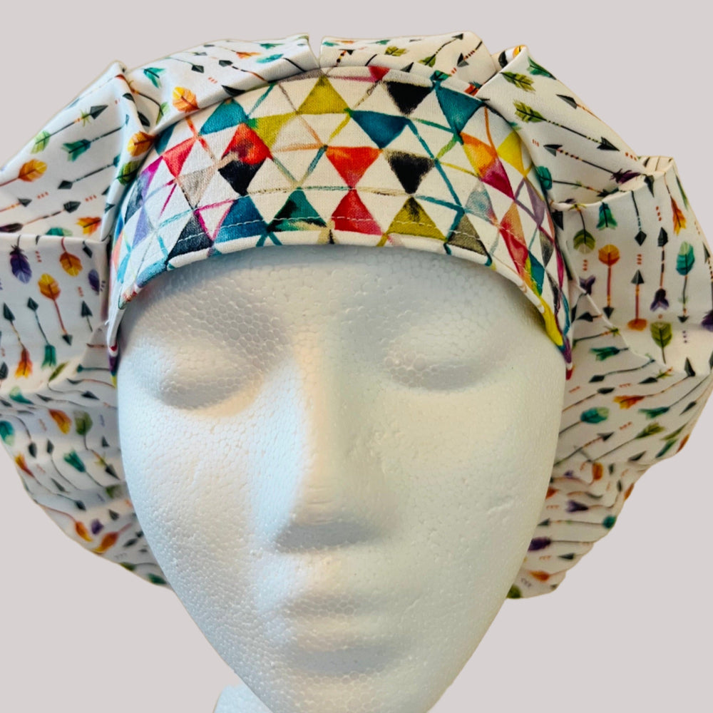 Side view of colorful arrows bouffant scrub cap — handmade USA surgical hat for OR nurses with room for long hair.