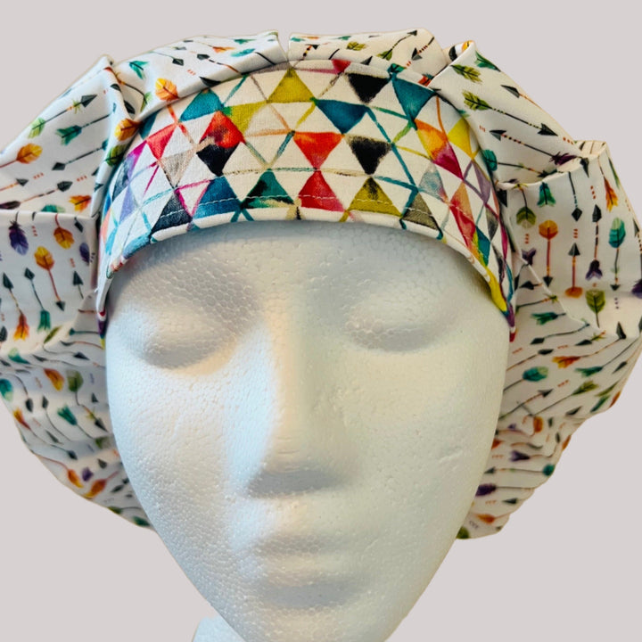 Side view of colorful arrows bouffant scrub cap — handmade USA surgical hat for OR nurses with room for long hair.