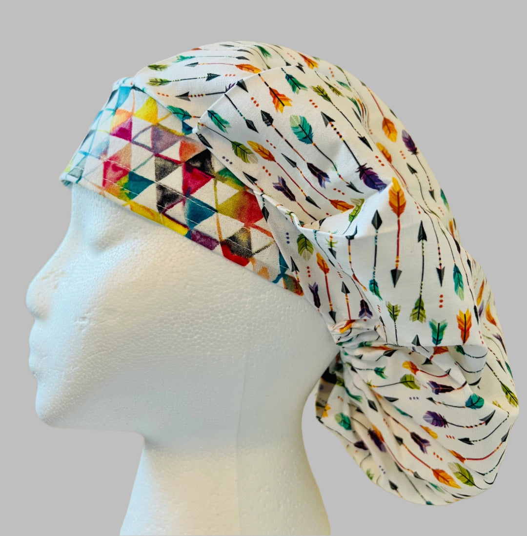 Top view of white &amp; rainbow arrow bouffant scrub cap — handmade-in-USA surgical hat, cheerful gift for nurses &amp; surgeons.
