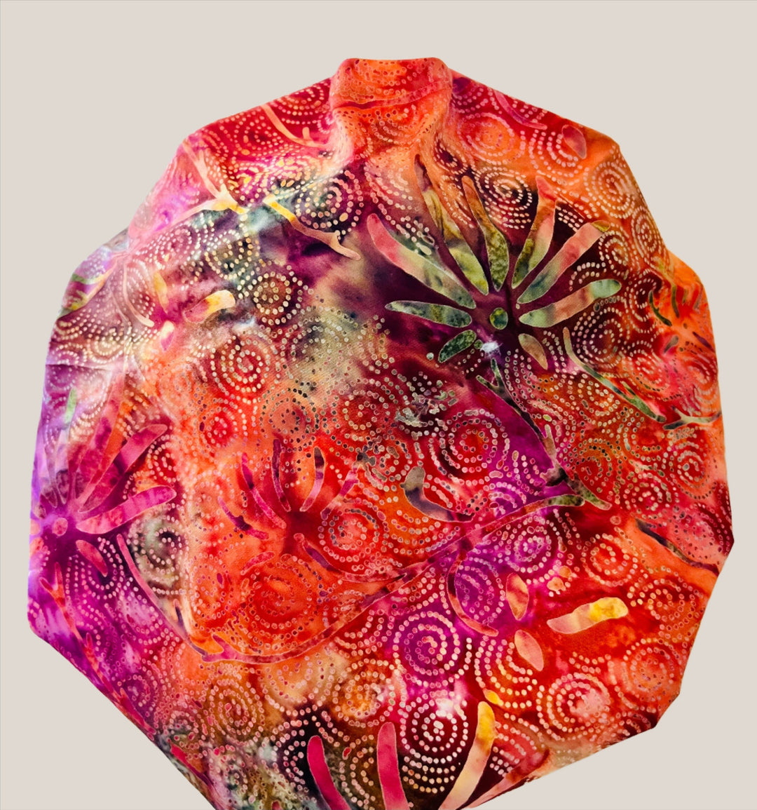 Back view of fuchsia citrus batik bouffant scrub cap for women — handmade-in-USA OR World surgical hat with elastic adjustable fit.