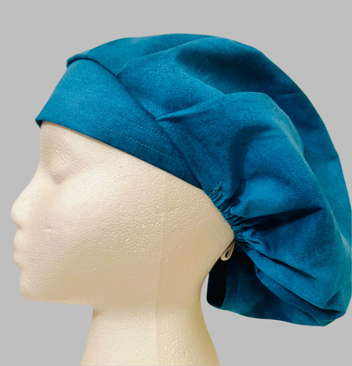 Solid country blue bouffant scrub cap, plain blue, on a model — handmade-in-USA unisex surgical hat for men &amp; women from OR World.