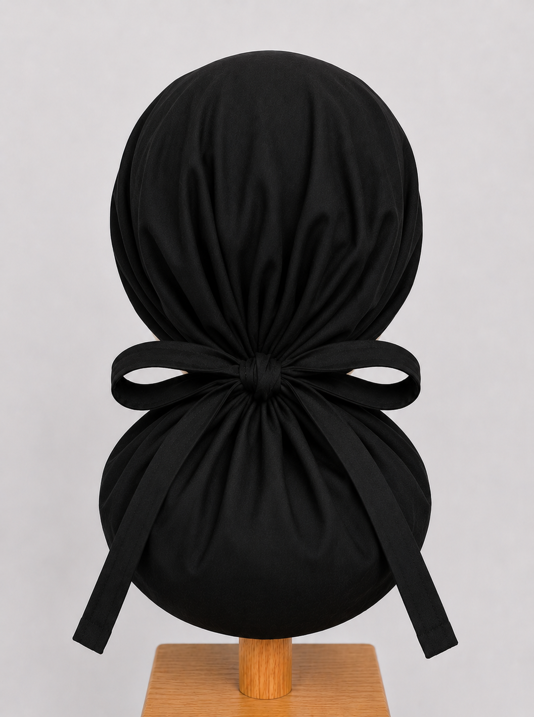 Black XL ponytail scrub cap back view showing tie closure and extra large hair pouch