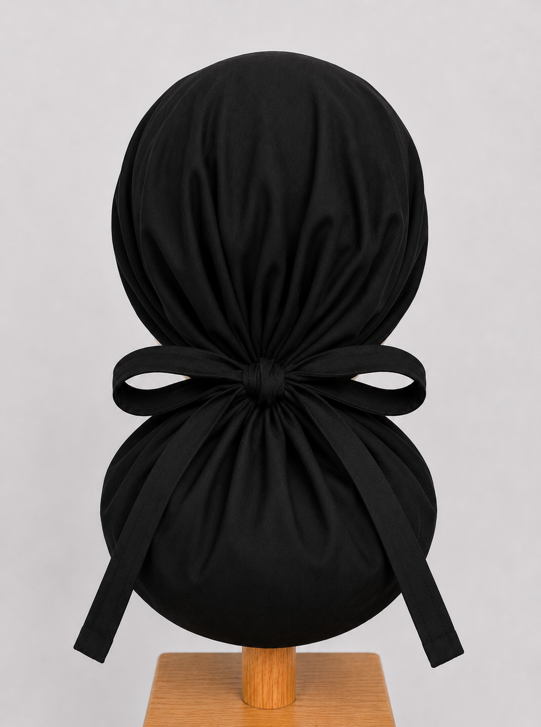 Black XL ponytail scrub cap back view showing tie closure and extra large hair pouch