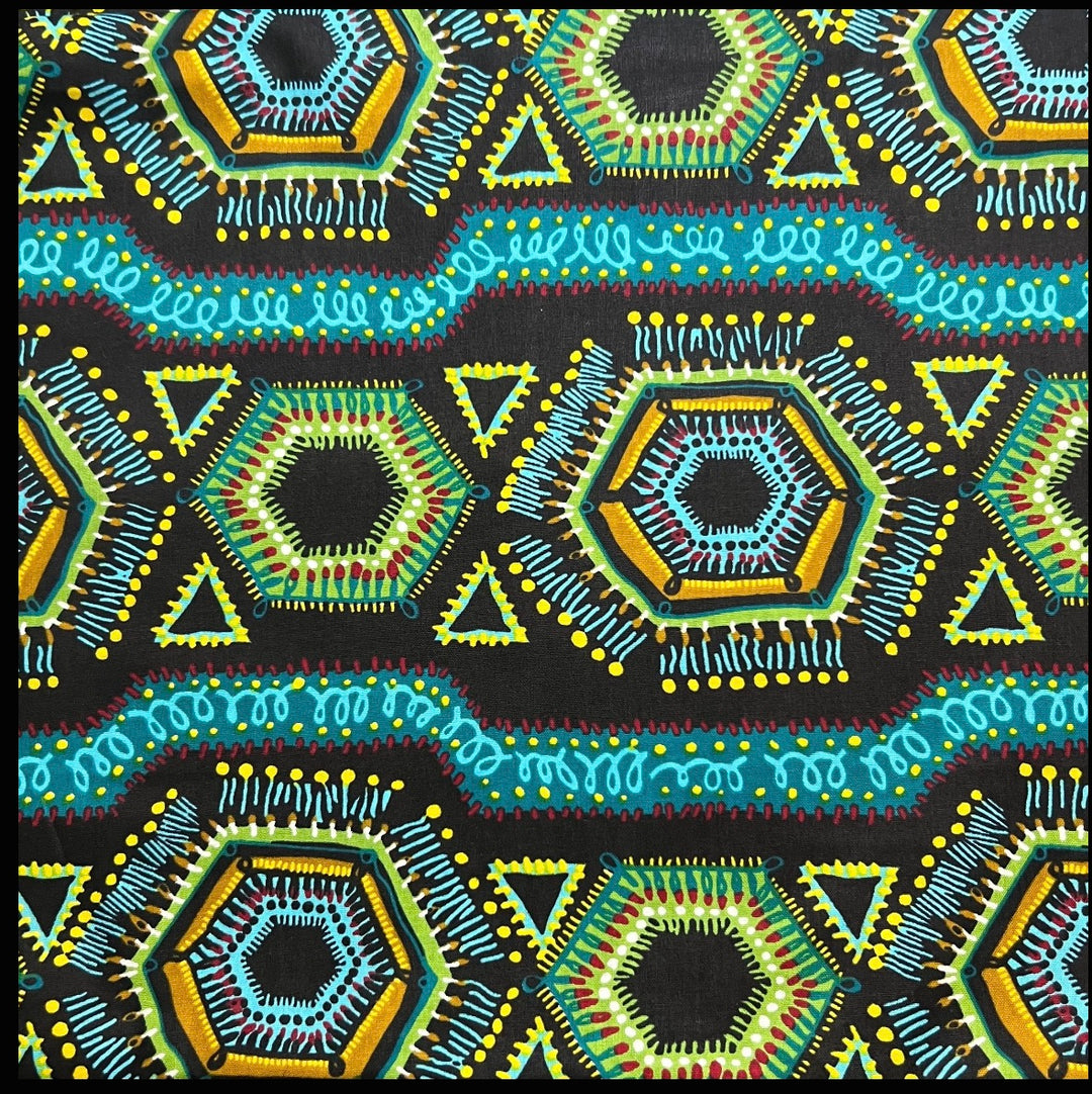 Flat fabric swatch of the African Ankara print: black ground with turquoise swirl bands, lime and gold hexagons, yellow dotted triangles and red stitch accents