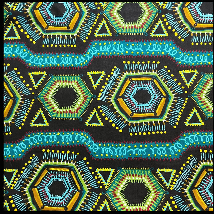 Flat fabric swatch of the African Ankara print: black ground with turquoise swirl bands, lime and gold hexagons, yellow dotted triangles and red stitch accents