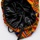 Colorful Geometric African Kente bouffant scrub cap flat lay showing black satin lining interior bold Ghana triangle pattern surgical hat handmade USA