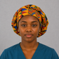 Nurse wearing Colorful Geometric African Kente bouffant scrub cap bold gold blue red green triangle pattern Ghana surgical hat teal scrubs OR World