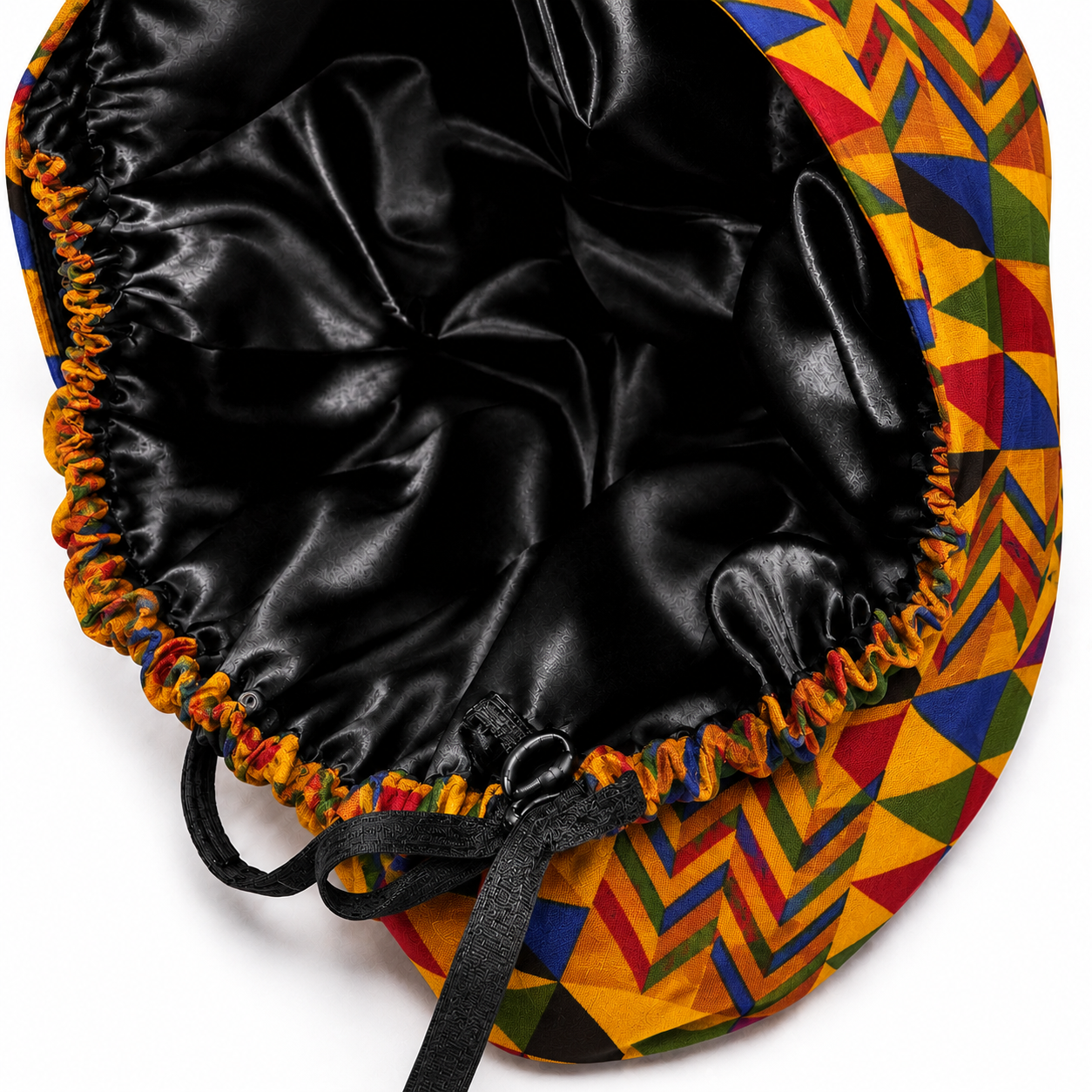 Colorful Geometric African Kente ponytail scrub cap flat lay showing black satin lining interior bold Ghana triangle pattern surgical hat handmade USA OR World