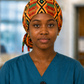 Nurse wearing Empowered Energy African Kente ponytail scrub cap traditional Ghana diamond pattern orange green teal black surgical hat hospital setting OR World