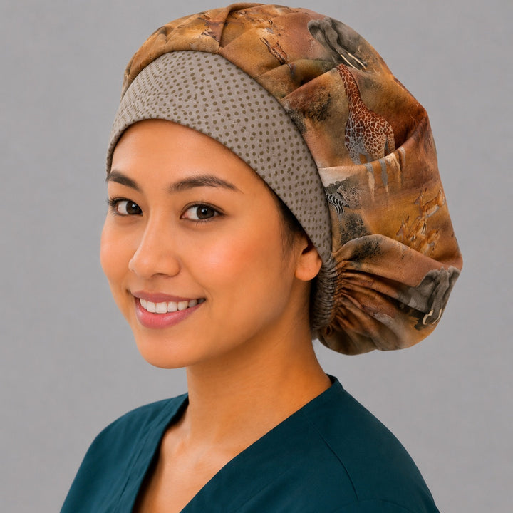 African safari bouffant scrub cap right three-quarter view on smiling model — elephant, giraffe and zebra savanna print with taupe dot band, adjustable women&