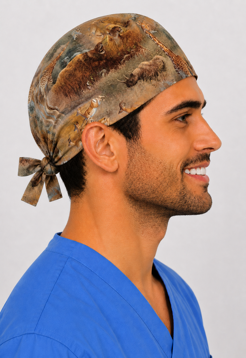 Man wearing African safari wildlife tie-back scrub cap with elephants, giraffes &amp; lions, front view — handmade-in-USA men&