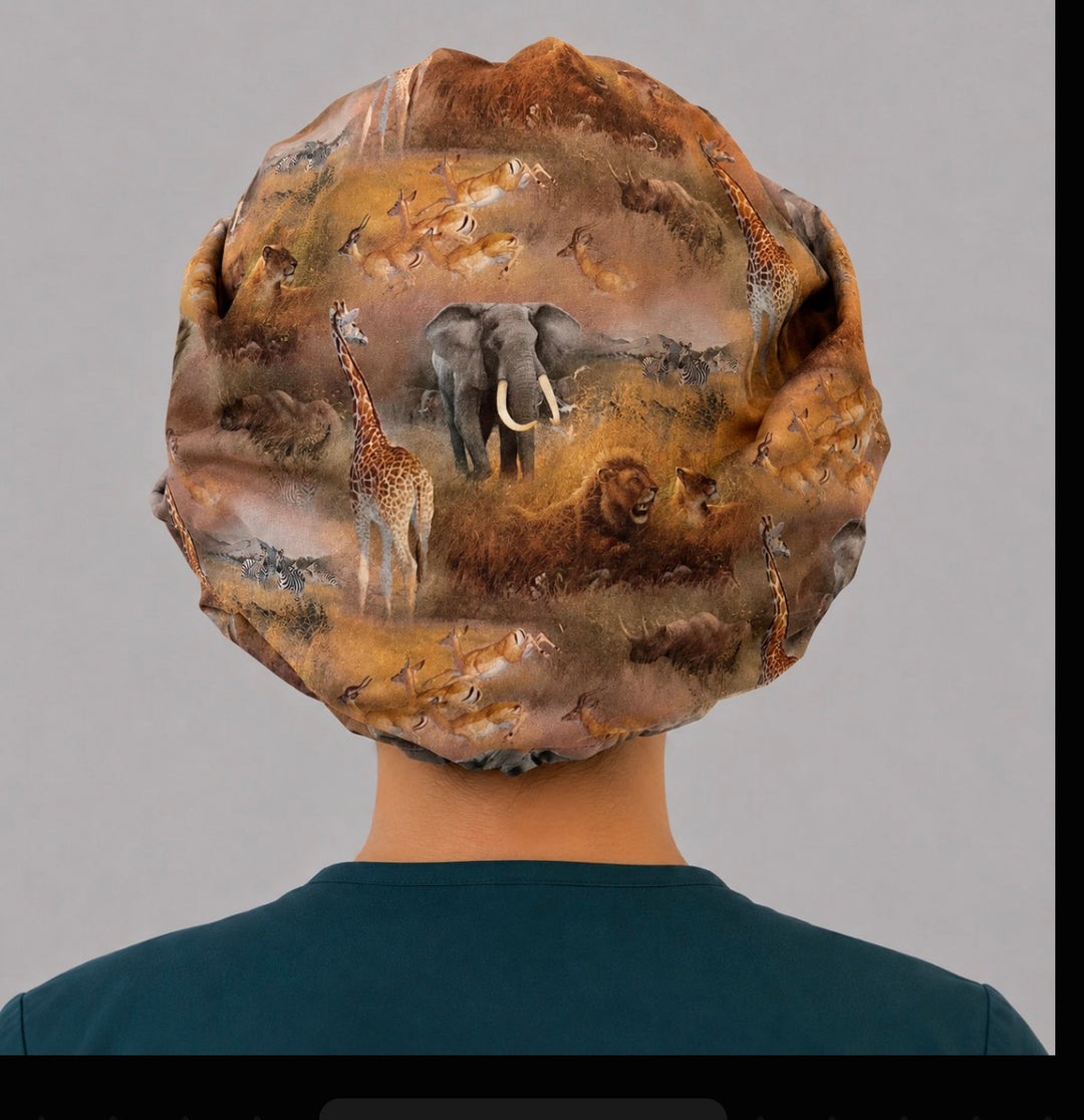 African safari bouffant scrub cap back view showing full savanna scene of elephant, lion, giraffe and zebra on golden grassland, OR World