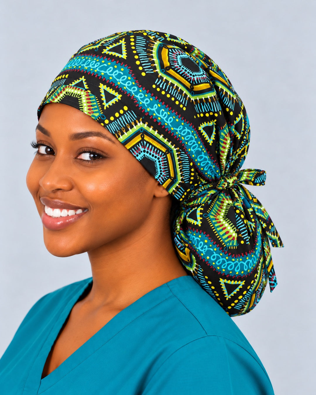Right three-quarter view of an African wax print XL ponytail cap, with a large gold-edged hexagon medallion centered on the roomy crown