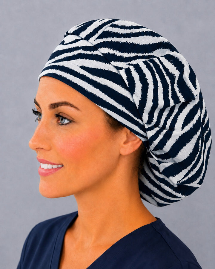 Animal print zebra bouffant scrub cap, left side profile — roomy elastic-back fit that secures long thick or braided hair