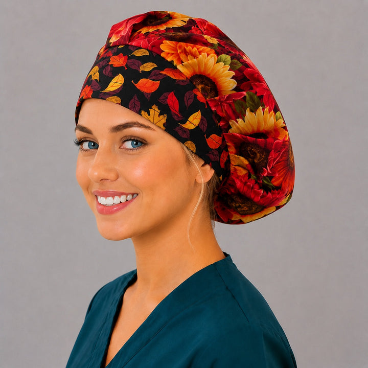 Right side profile of the autumn sunflower bouffant surgical hat — crimson and gold blooms with falling leaf band, roomy breathable cotton cap