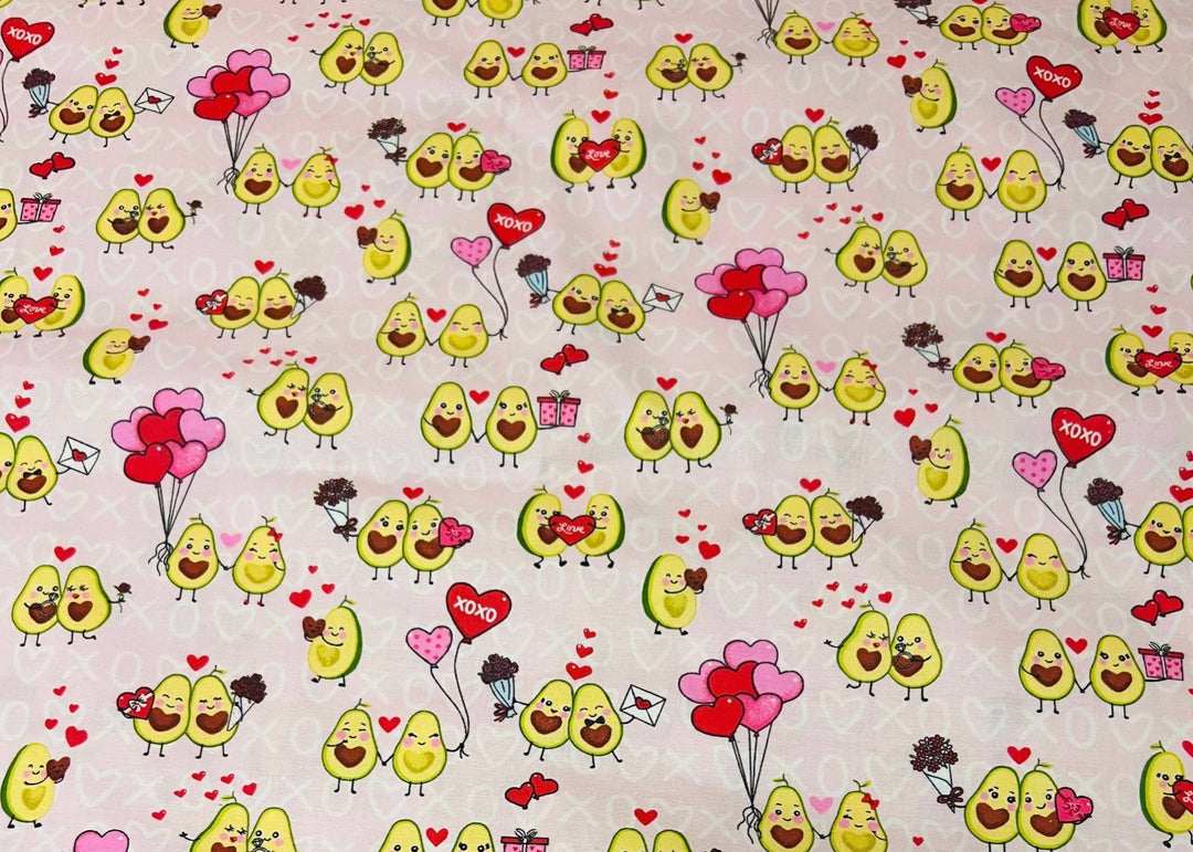 Fabric detail of the Avocado Love scrub cap — close-up of avocado couples, hearts and XOXO print on pink cotton