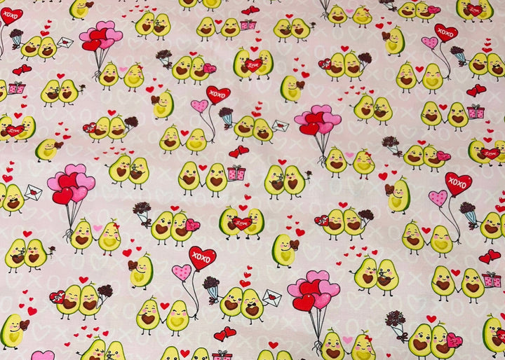 Fabric detail of the Avocado Love scrub cap — close-up of avocado couples, hearts and XOXO print on pink cotton