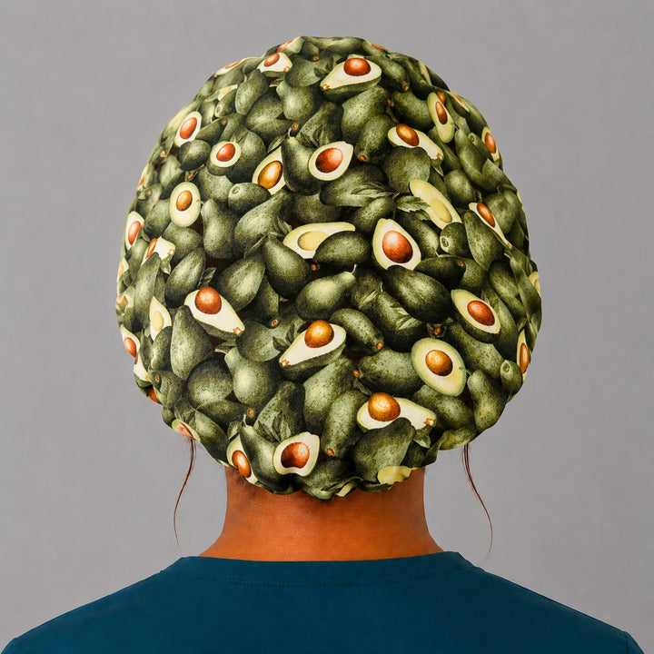 Avocado print bouffant scrub cap back view showing full print of whole and halved avocados on green, OR World foodie surgical hat