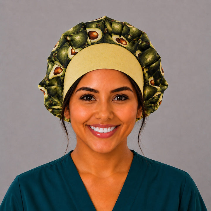 Avocado print bouffant scrub cap for women, front view, realistic whole and halved avocados with buttery-yellow band, handmade foodie surgical hat by OR World