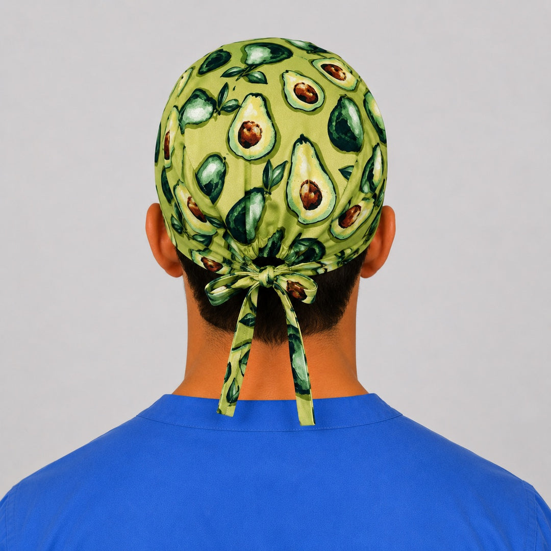 Back view of the sage green avocado tie-back scrub cap showing the bow tie closure and full avocado print