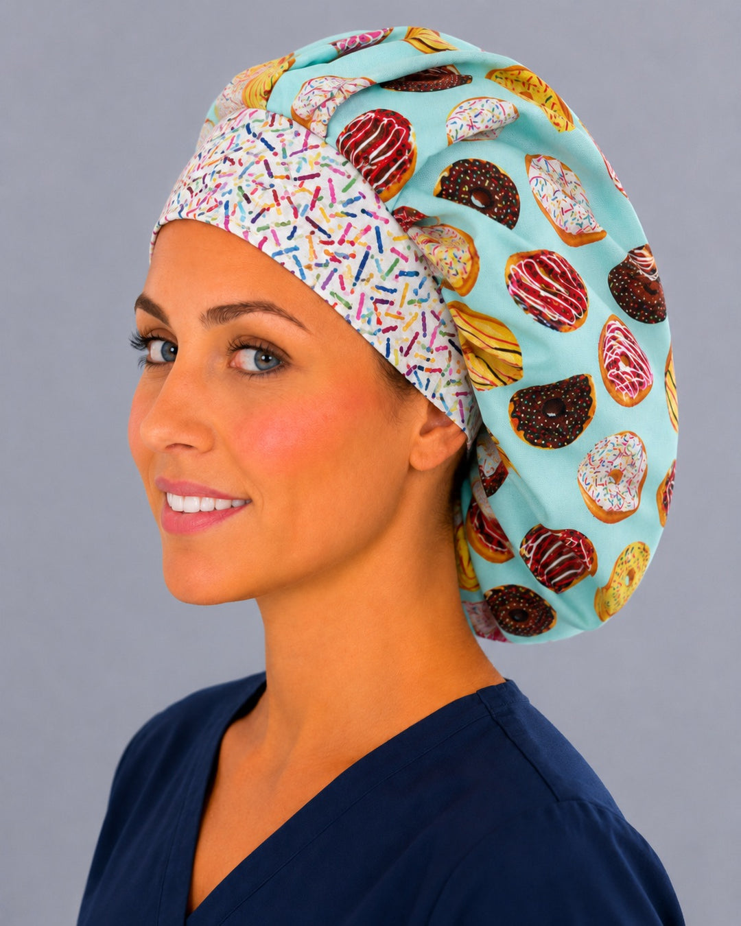 Bakery and dessert bouffant cap for women, angled smiling view — donut print surgical cap handmade in the USA