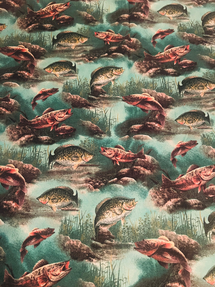 Close-up of bass, crappie and freshwater fish fabric swatch, teal lake fishing scrub cap print detail