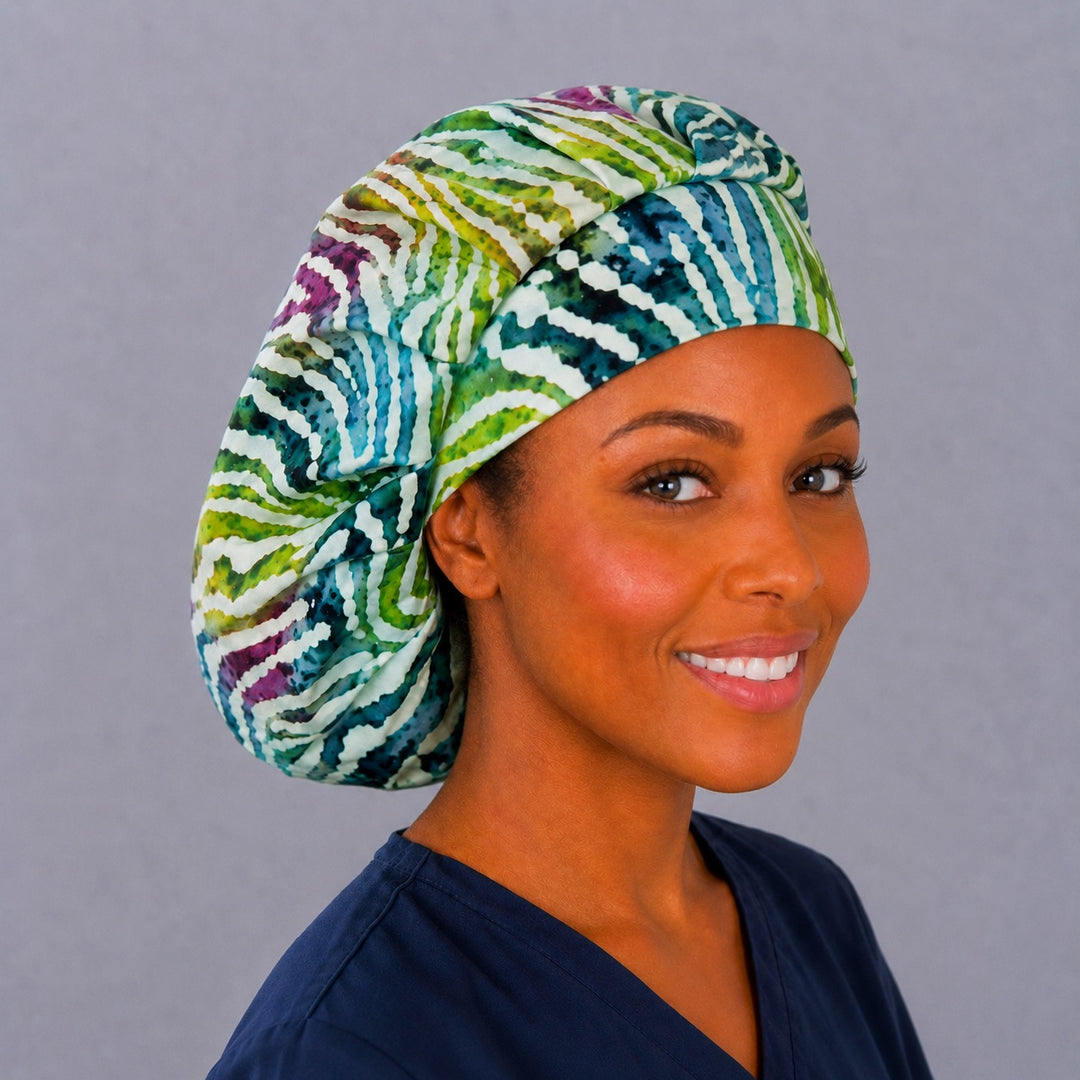 Batik zebra bouffant scrub cap, right angled smiling view — teal and magenta stripe print for OR nurses and surgical techs