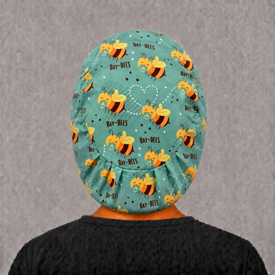Right side profile of the Bay-Bees Euro surgical hat — baby bee and heart trail print, breathable cotton cap for NICU and L&amp;D nurses
